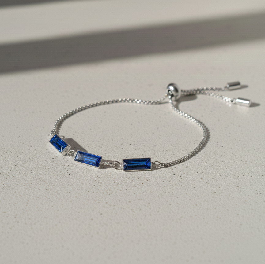 Silver stainless steel pull tie bracelet with blue rhinestones