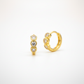 Gold hoop earrings with heart-shaped CZ
