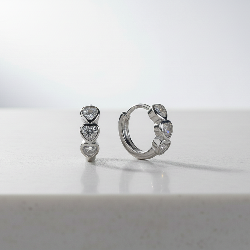 Pair of silver hoop earrings with heart-shaped CZ