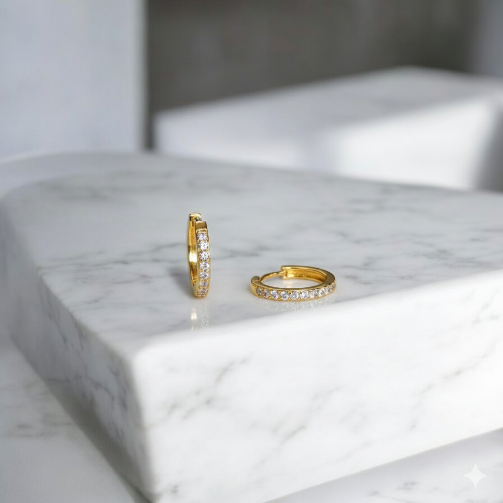 Two gold hoop earrings with CZ
