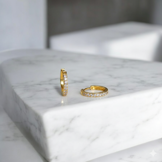 Two gold hoop earrings with CZ